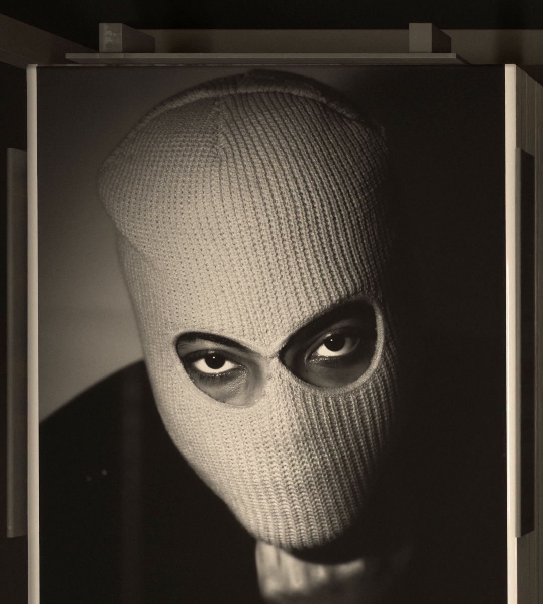 From straight above, the balaclava print lies square on the pile.